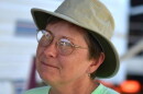 A photo of KCUR volunteer Becky Welch in a green t-shirt and sun hat