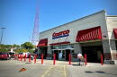 Entrance to the Costco store in Midtown Kansas City with a tall red broadcast tower and a butterfly
