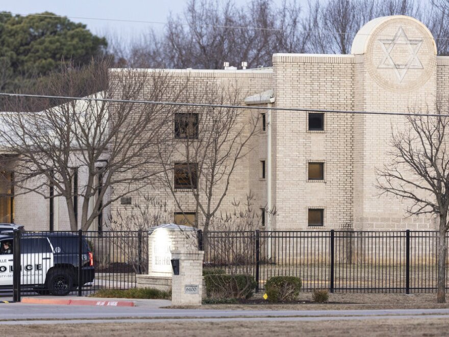 Police stand in front of the Congregation Beth Israel synagogue, Sunday, Jan. 16, 2022, in Colleyville, Texas.