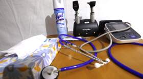 A stethoscopes and blood pressure monitor on set on a rolling rolling table. (Rogelio V. Solis/AP)