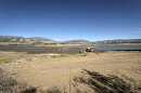 Crews haul rocks to build a temporary road across Pineview Reservoir, Sept. 14, 2026.