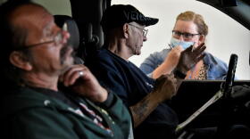 Workers get information about job openings at a drive-thru employment fair in Elkhart during the pandemic.