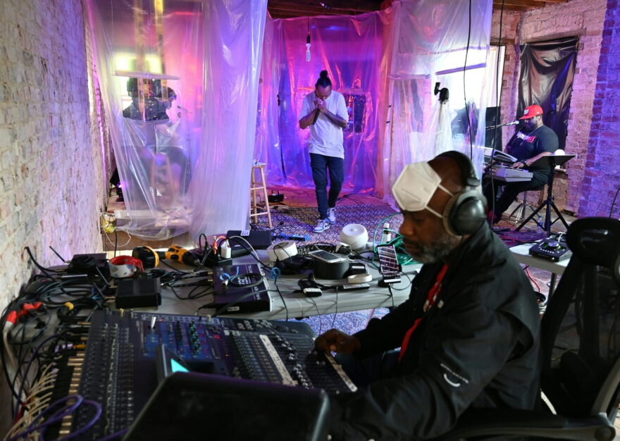Jazz harmonica player Frederic Yonnet (C) does a "social distancing" sound check, separated by a plastic tarp from band members (from L) Robbie McDonald on the guitar, Dennis Turner on the bass, Christopher Bynum at the drums and Warren Jones on the keyboard with sound man Eric Harris, before live streaming the concert on his Instagram and Facebook accounts. 
