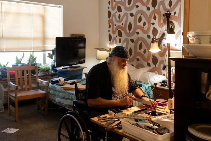 Norris works on woodworking projects and art drawings. He takes five or six medications a day and goes to a wound care facility three times a week, a preventative regiment he says he never could have maintained while living in a tent.