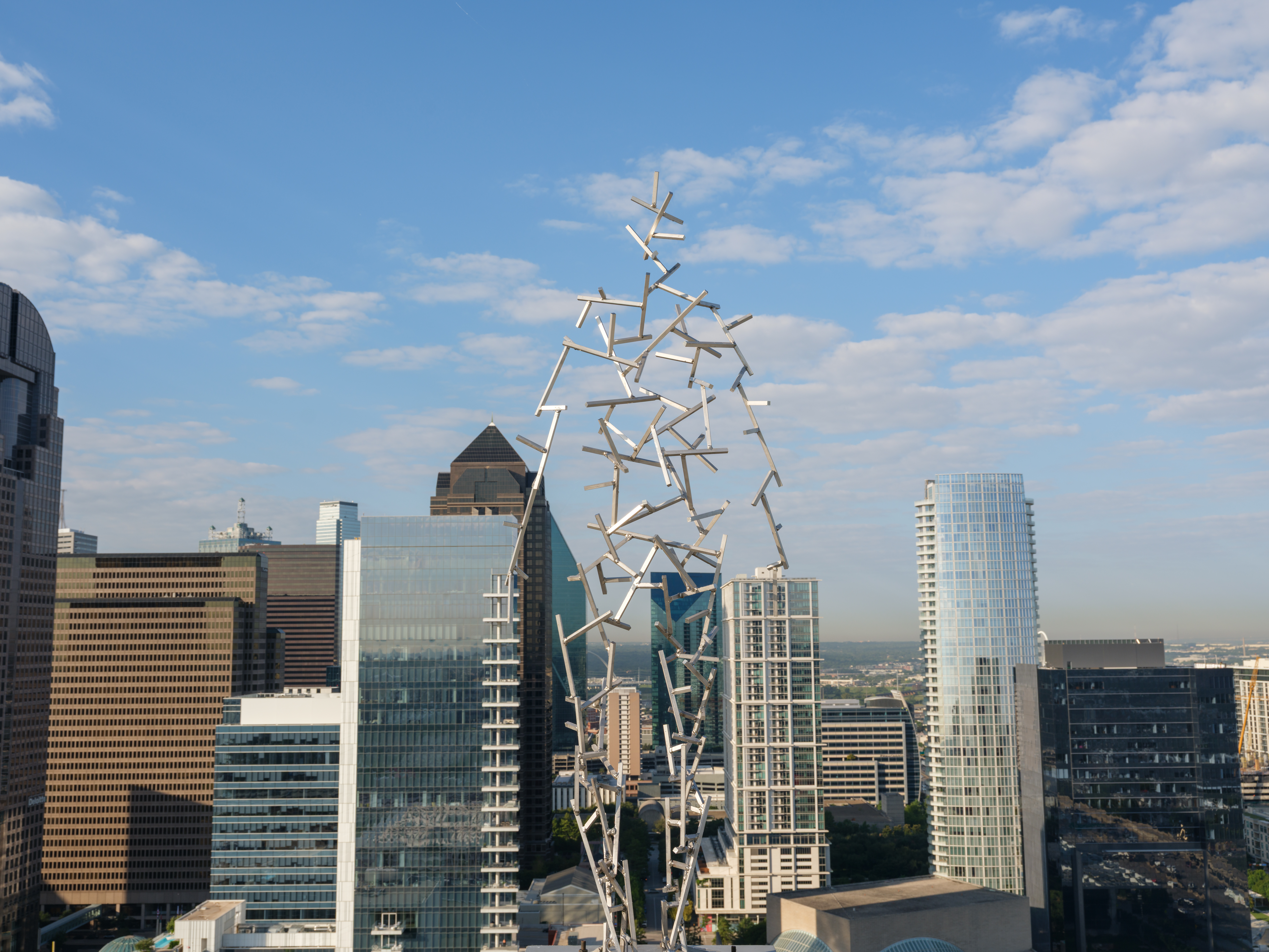 Humanlike sculptures are perched on Dallas rooftops. Here's why