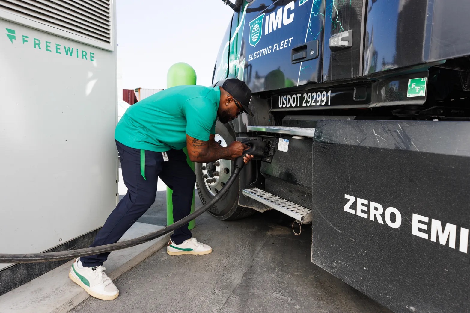 Khari Burton of IMC Logistics demonstrates how to charge a zero-emissions big rig