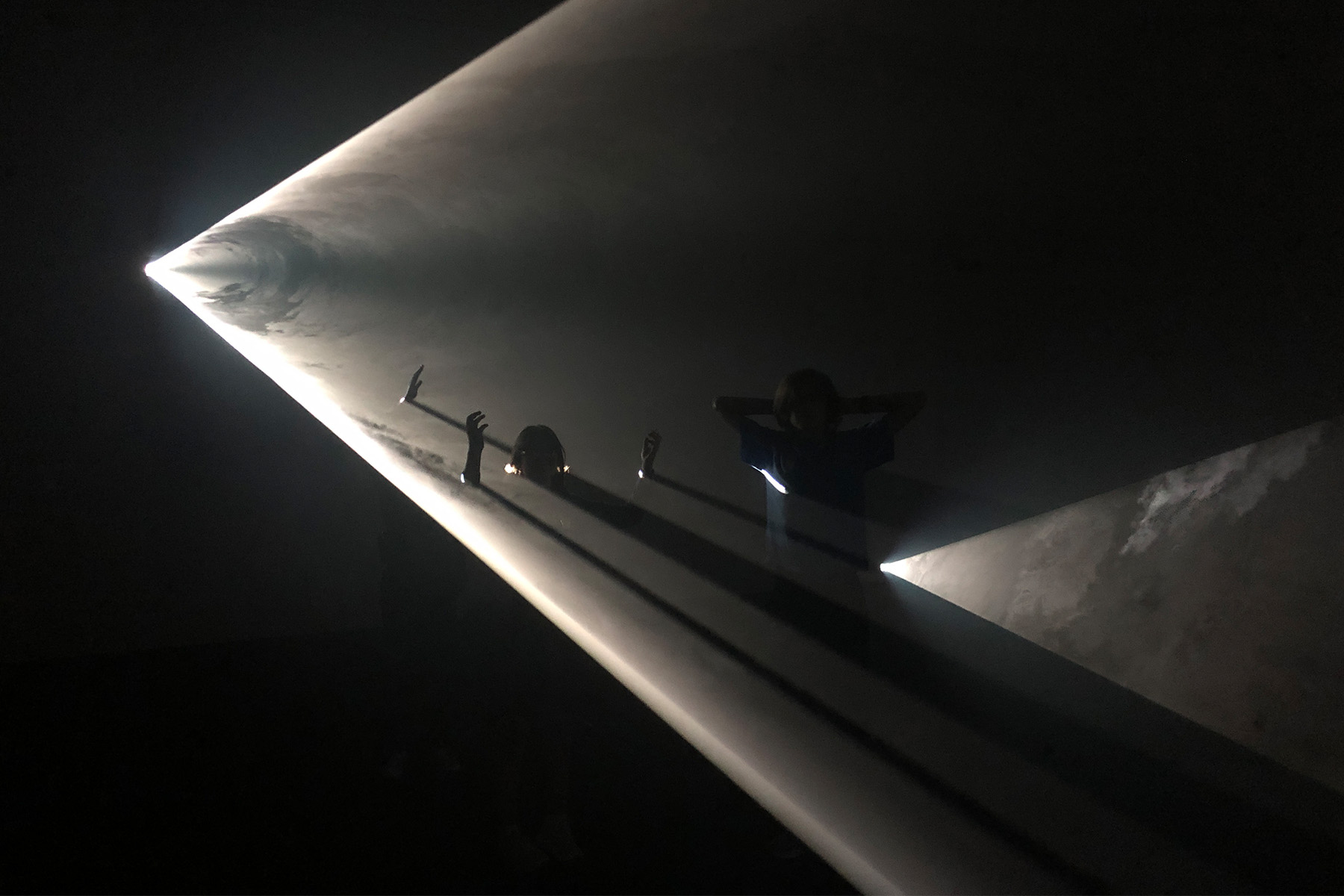 Kids interacting at Anthony McCall’s Swell exhibit, 
         Nevada Museum of Art