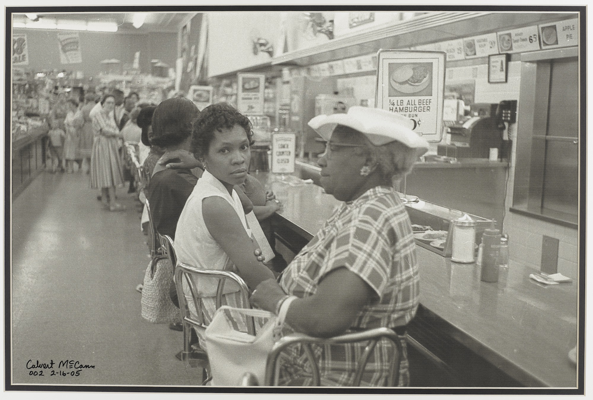 Historical photograph of people seated at a lunch counter, accompanying the Audrey Grevious radio feature